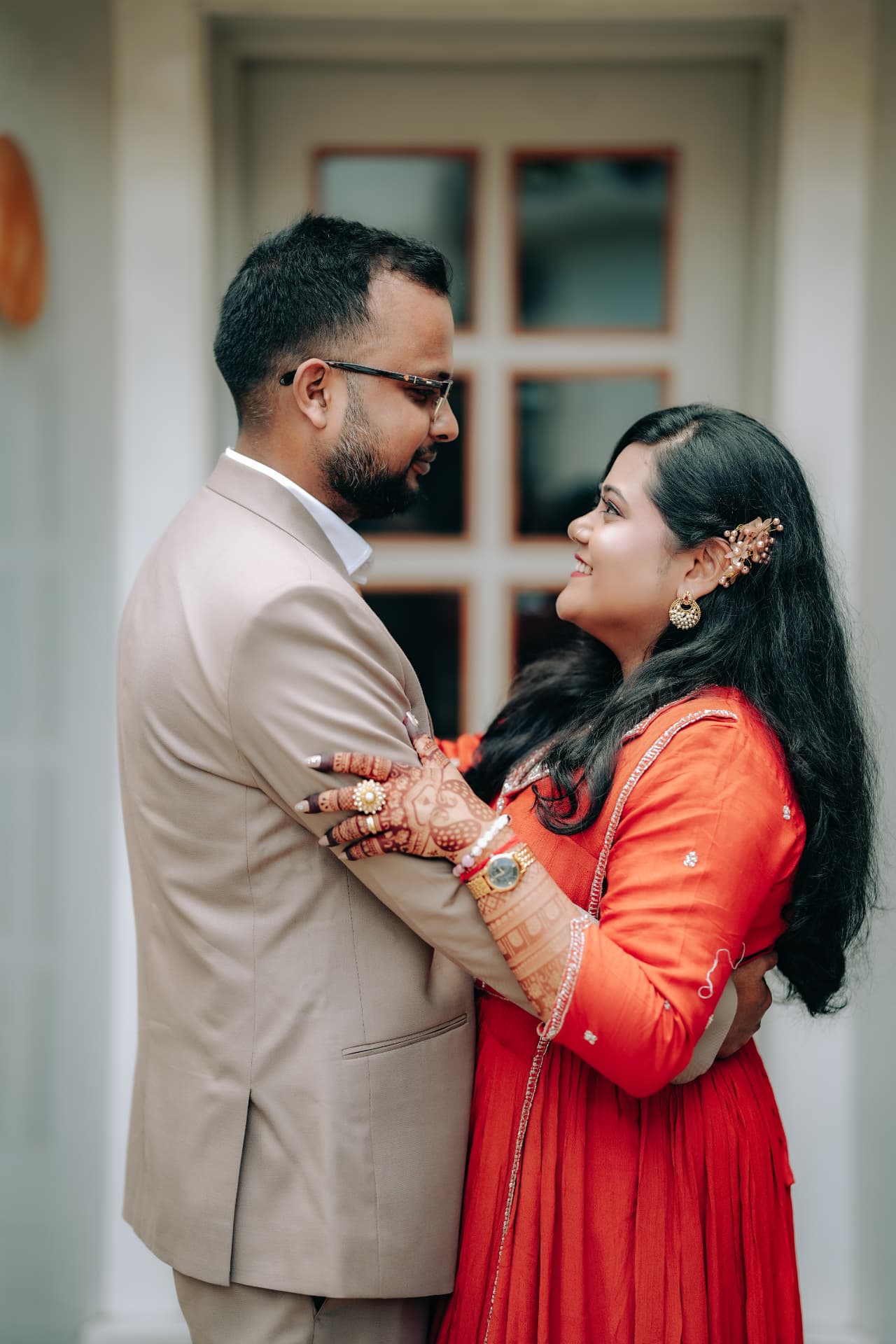 Survi and Kunal embracing outside a doorway